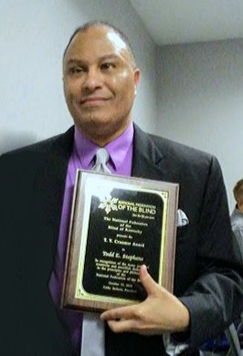 Photo of Todd Stephens receiving 	T.V. Kramner Award at 2018 NFBK Convention